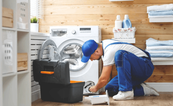 Appliance engineer repairing a washing machine