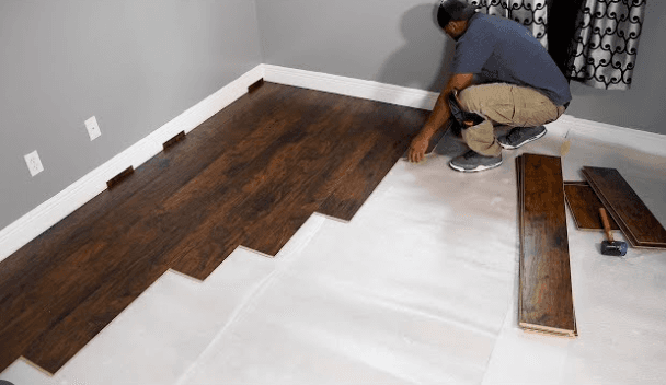Engineered wood flooring being installed in a room
